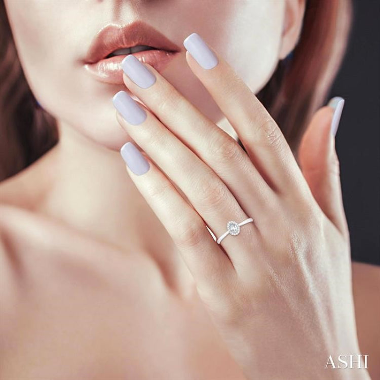 5x3 MM Oval Shape White Topaz and 1/20 Ctw Round Cut Diamond Halo Semi-Precious Ring in 10K White Gold