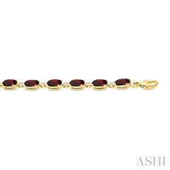 6X4 MM Oval Cut Garnet and 1/6 Ctw Round Cut Diamond Semi-Precious Tennis Bracelet in 10K Yellow Gold